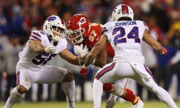 Travis Kelce of the Kansas City Chiefs runs between two defenders during a playoff game Jan. 23 against the Buffalo Bills.