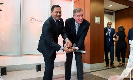 Octo CEO Mehul Sanghani (left) and Sen. Mark Warner (D-Virginia) mark the opening of oLabs with a ribbon cutting.