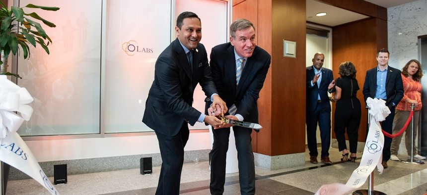 Octo CEO Mehul Sanghani (left) and Sen. Mark Warner (D-Virginia) mark the opening of oLabs with a ribbon cutting.