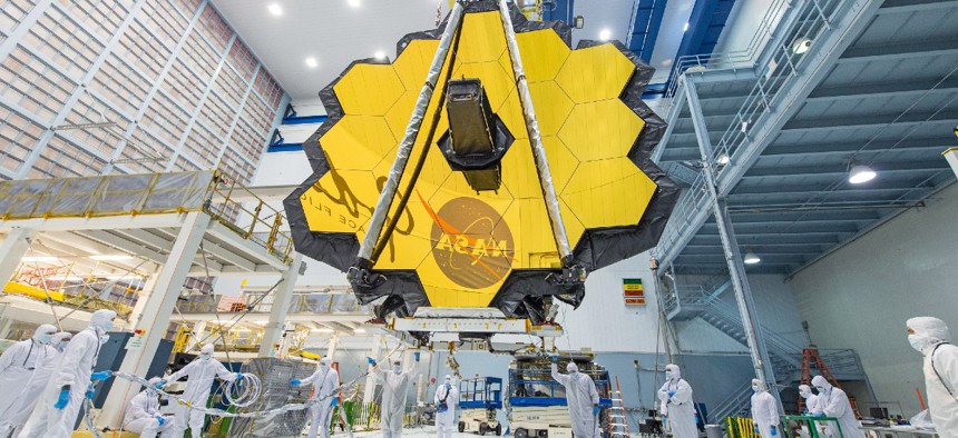 NASA technicians prep the James Webb telescopes primary mirror, which will capture infrared light from the first galaxies that formed in the early universe. The mirror was folded to fit into the spacecraft and then unfolded once the telescope established its orbit around the sun.