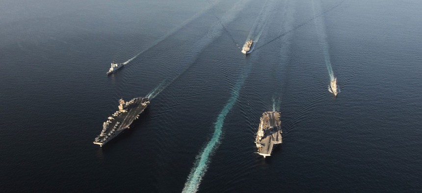 A fleet of Navy ships transit the Arabian Sea.