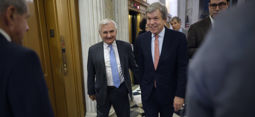 Sen. Jack Reed (D-RI) (L) and Sen. Roy Blunt (R-MO) head for the Senate Chamber for a procedural vote on the bipartisan federal omnibus spending legislation at the U.S. Capitol on December 20, 2022 in Washington, DC.
