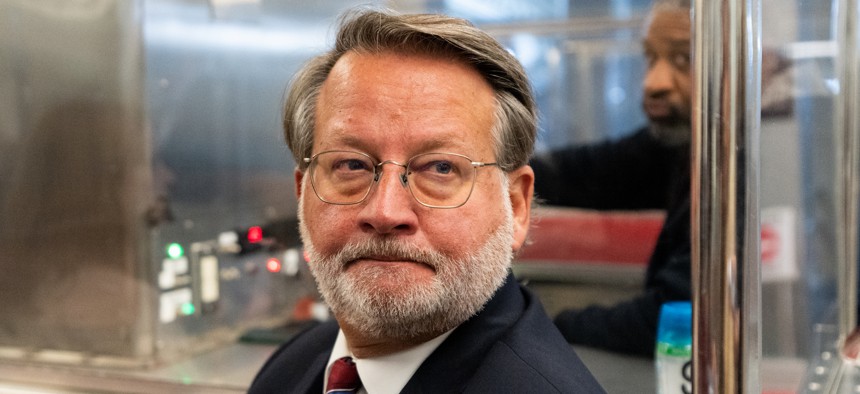 Sen. Gary Peters (D-Mich.) talks to reporters on the Senate subway