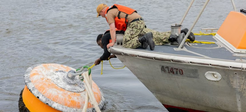 Marines tie a boat to a buoy as part of a hurricane preparedness drill at Marine Corps Air Station Cherry Point in North Carolina.