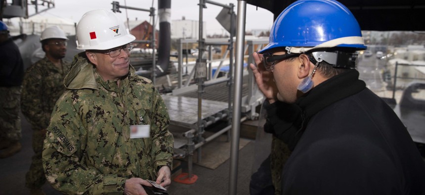 Rear Adm. Kurt Rothenhaus is saluted by USS Gerald R. Ford (CVN 78) messenger of the watch prior to a tour of the ship, Dec. 8, 2021. 