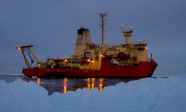 The research vessel Nathaniel B. Palmer cruises the darkened waters of Marguerite Bay on the Antarctic Peninsula. 