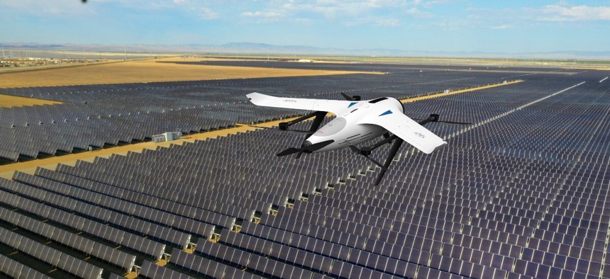 A Hevendrones H2D200 flying over a solar panel farm.