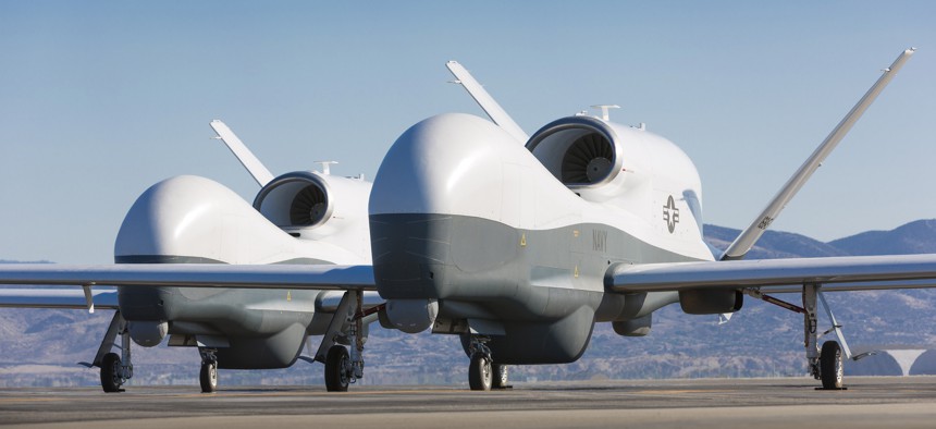 Two Northrop Grumman MQ-4C Triton unmanned aerial vehicles on the tarmac at a Northrop Grumman test facility in Palmdale, California. 