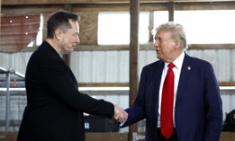 Elon Musk (L) shakes hands with former President Donald Trump back stage during a campaign rally at the Butler Farm Show grounds on October 05, 2024. The president-elect has vowed to create a government efficiency commission under Musk that will recommend "drastic reforms."