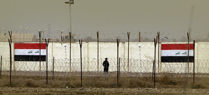 An Iraqi security officer patrols the grounds of the former Abu Ghraib prison, which is now known as the Baghdad Central Prison.