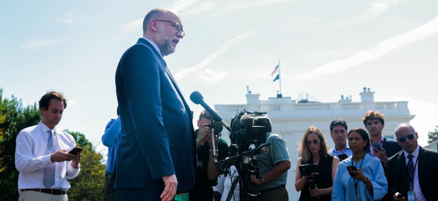 OMB Director Russell Vought speaks with reporters outside the White House on July 17.