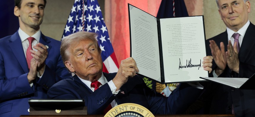 U.S. President Donald Trump displays a signed executive order during the "Winning the AI Race" summit hosted by All‑In Podcast and Hill & Valley Forum at the Andrew W. Mellon Auditorium on July 23, 2025 in Washington, DC. Trump signed executive orders related to his Artificial Intelligence Action Plan during the event.
