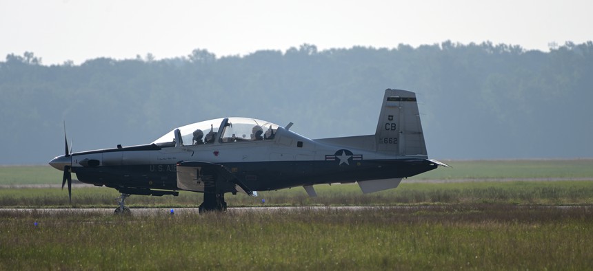 A student and instructor pilot taxi a T-6 plane at Columbus Air Force Base, Mississippi.