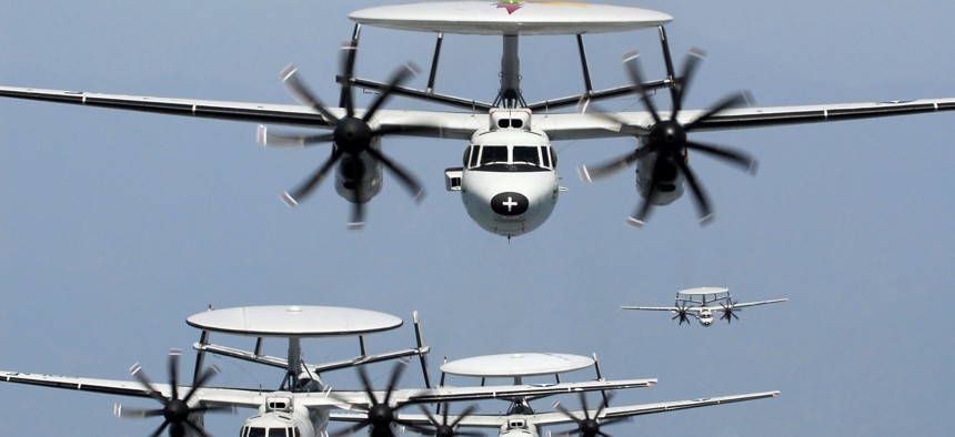 A group of EC-2 Hawkeyes fly in formation.