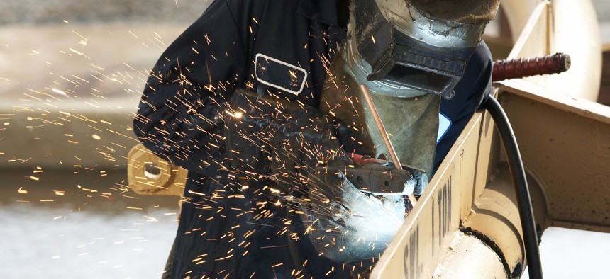 A welder at work on a new ship.