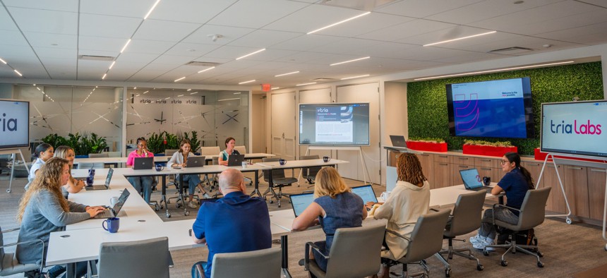 A meeting of Tria Labs team members.