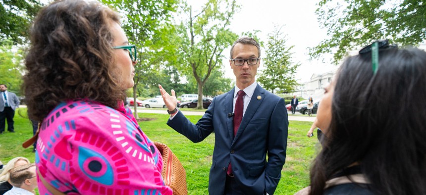 Rep. James Walkinshaw, (D-Va.), speaks with fired federal workers outside the U.S. Capitol in Washington on Sept. 30.