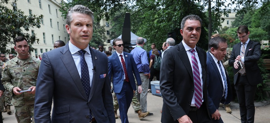 Defense Secretary Pete Hegseth (L) walks with Emil Michael (R), under secretary of defense for research & engineering, at the Pentagon, July 16, 2025.