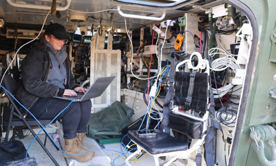 An engineer with the Army's C5ISR Center works on ways to use 5G technology to push data to the tactical edge using soldiers’ existing devices at Joint Base McGuire-Dix, New Jersey, on Jan. 7, 2026.