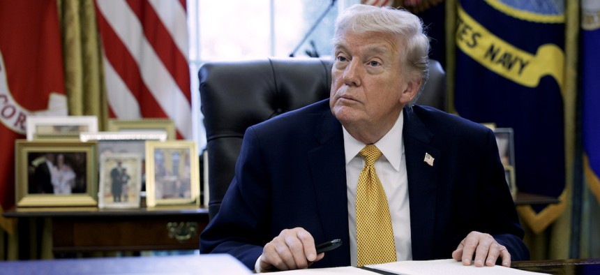 U.S. President Donald Trump prepares to sign paperwork during a White House signing ceremony in the Oval Office of the White House on March 16, 2026 in Washington, DC. Trump signed an executive order to create a task force on fraud which will be lead by Vice President J.D. Vance.
