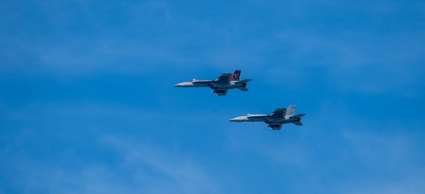 A pair of F-18 aircraft flying over Virginia Beach.