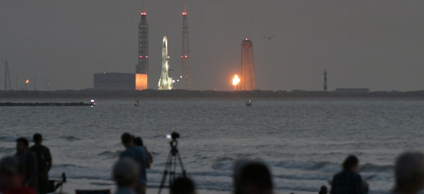 Spectators wait on the beach for a Blue Origin New Glenn rocket carrying an AST SpaceMobile Bluebird 7 satellite to launch from pad 36 at Cape Canaveral Space Force Station on April 19, 2026, in Cape Canaveral, Florida.