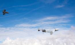 An interceptor drone pursues a kamikaze drone in the sky. (Digitally Generated Image)