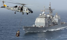 A Navy helicopter services the USS Vicksburg.