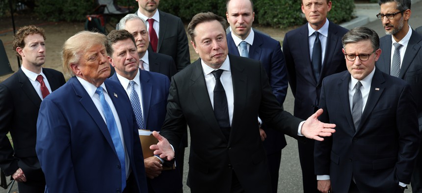 SpaceX CEO Elon Musk, center, stands with President Donald Trump, House Speaker Rep. Mike Johnson, R-LA., and others outside the White House on September 29, 2026.